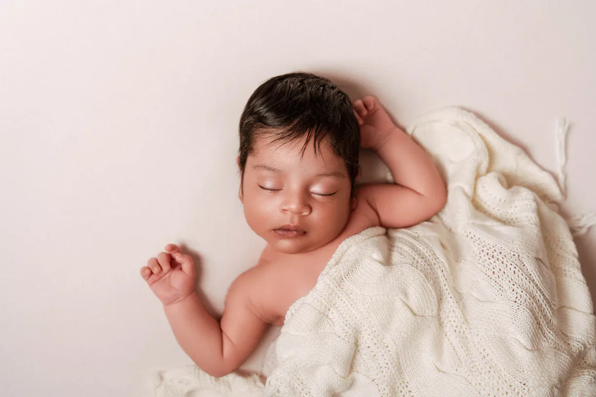 Sleeping baby photographed naturally during a home session