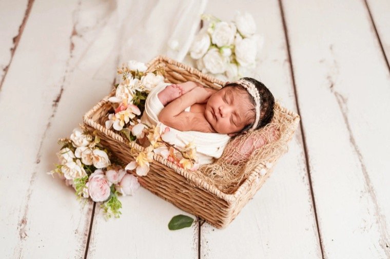 Newborn baby photoshoot at home with baby sleeping in a basket